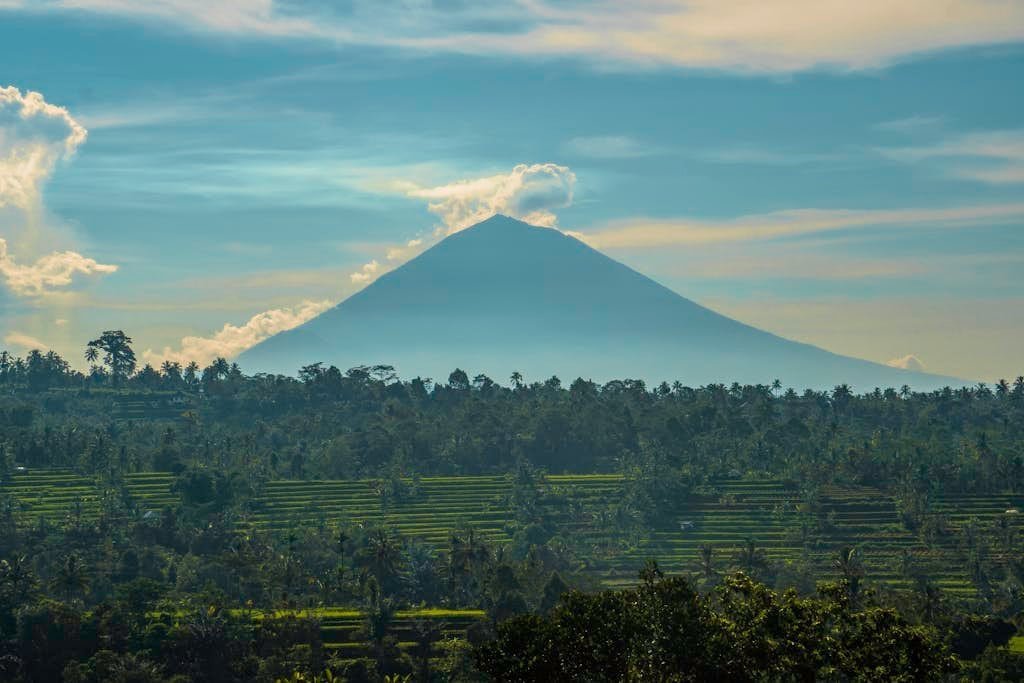 Stunning view of a volcano amidst lush greenery in Lampung, Indonesia. Perfect for nature lovers.