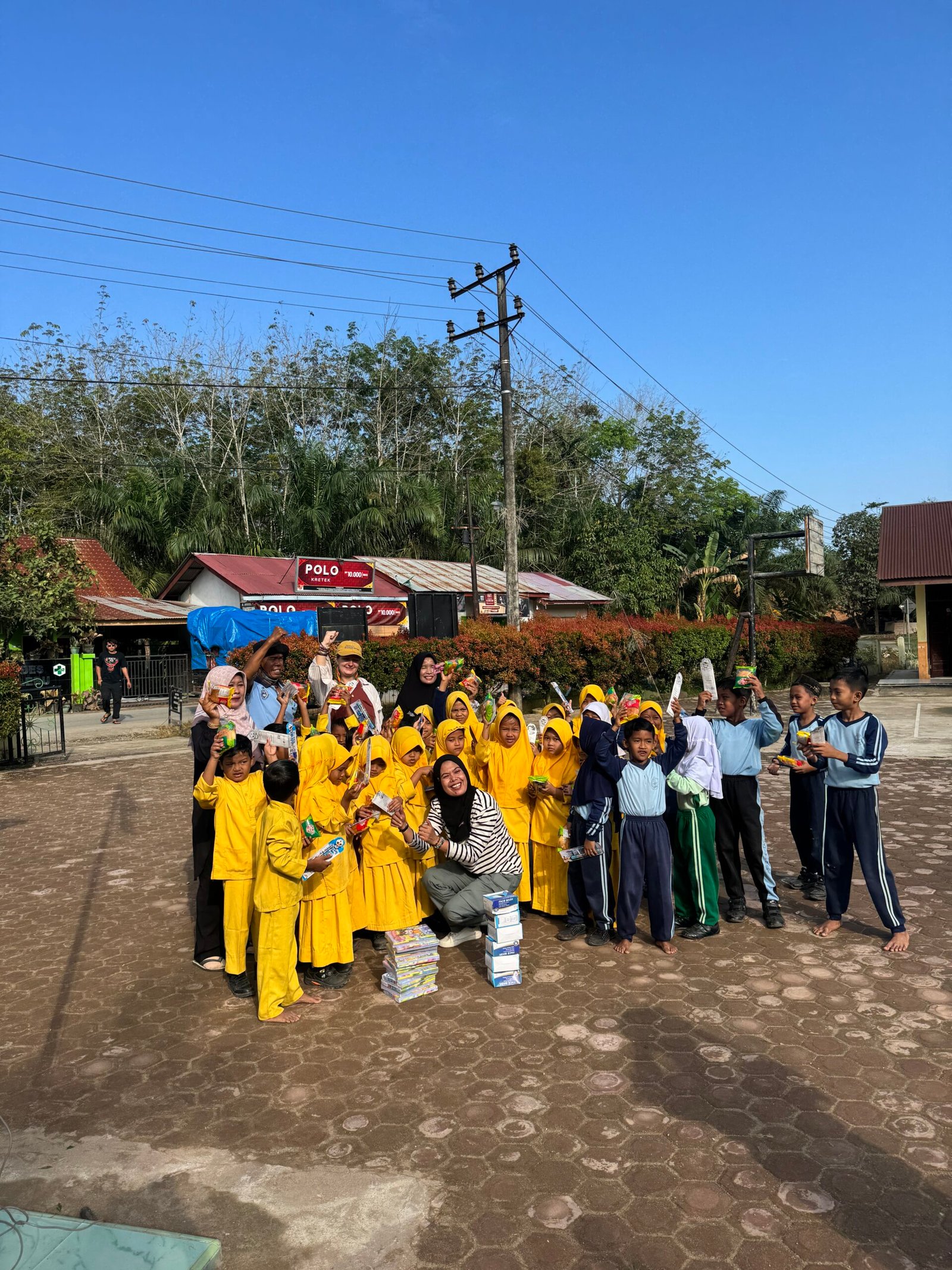 Local school children receiving new uniforms and supplies as part of our successful Aceh Relief Mission.