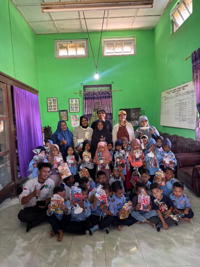 A photo of the kids at the 3 schools with their new uniforms or school supplies.