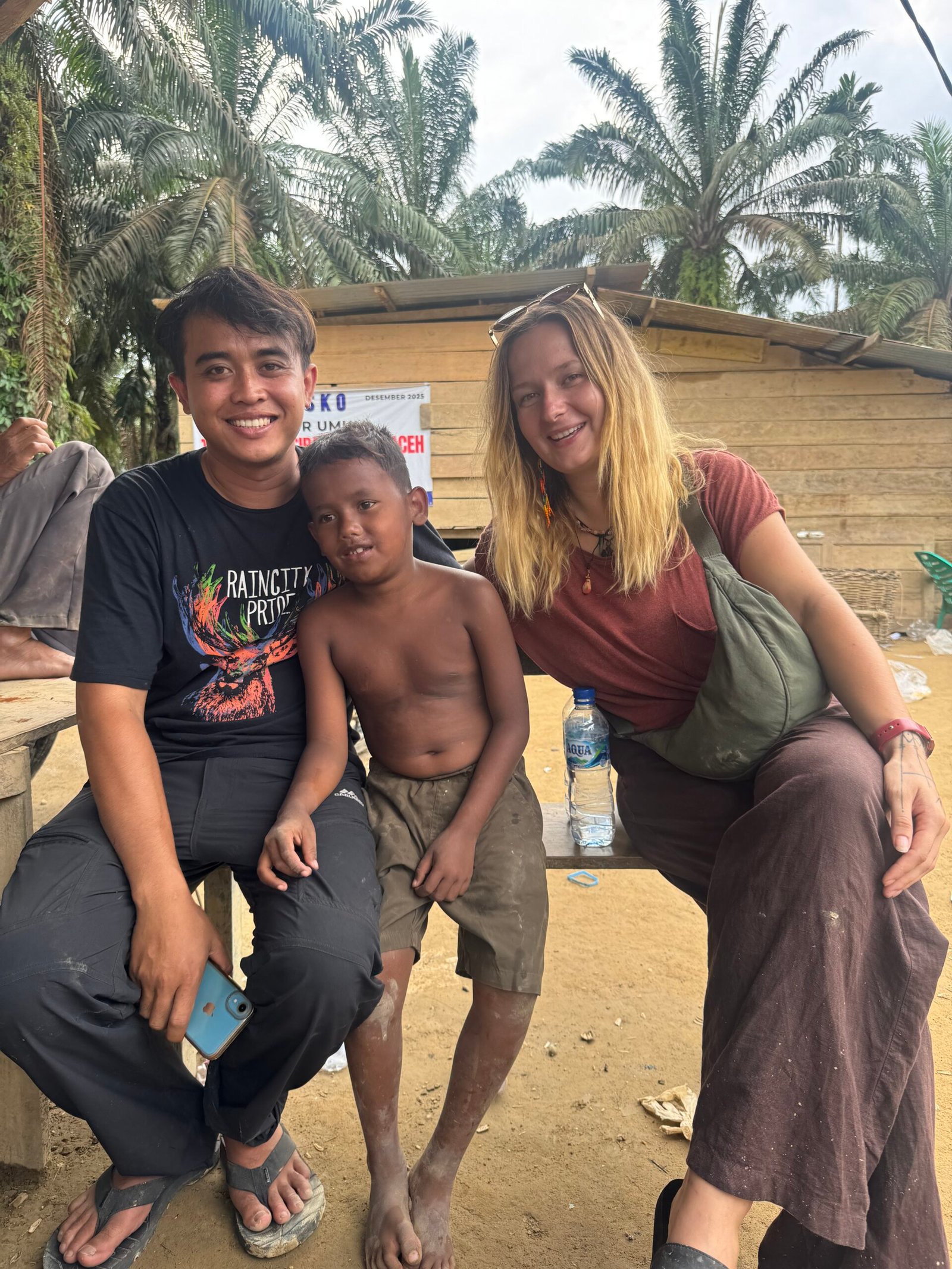 Children in a remote village smiling after receiving school supplies and uniforms during our Aceh Relief Mission.