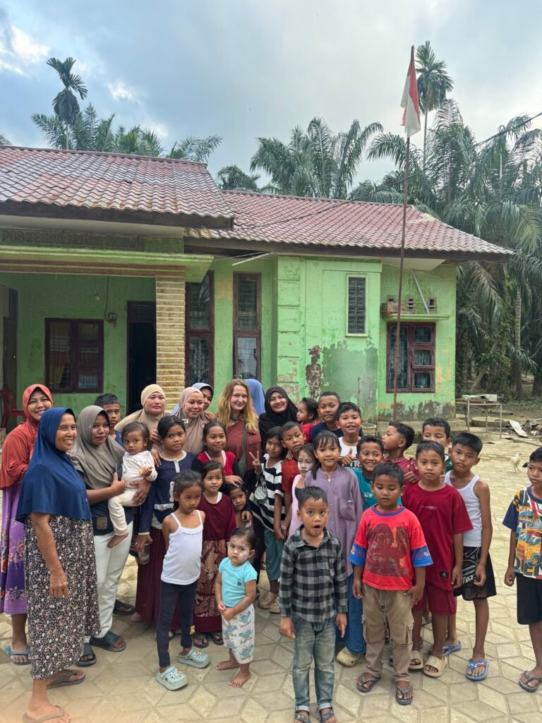 Community members in an Aceh village receiving critical aid and supplies from the Escape To Sumatra team during our Aceh Relief Mission.